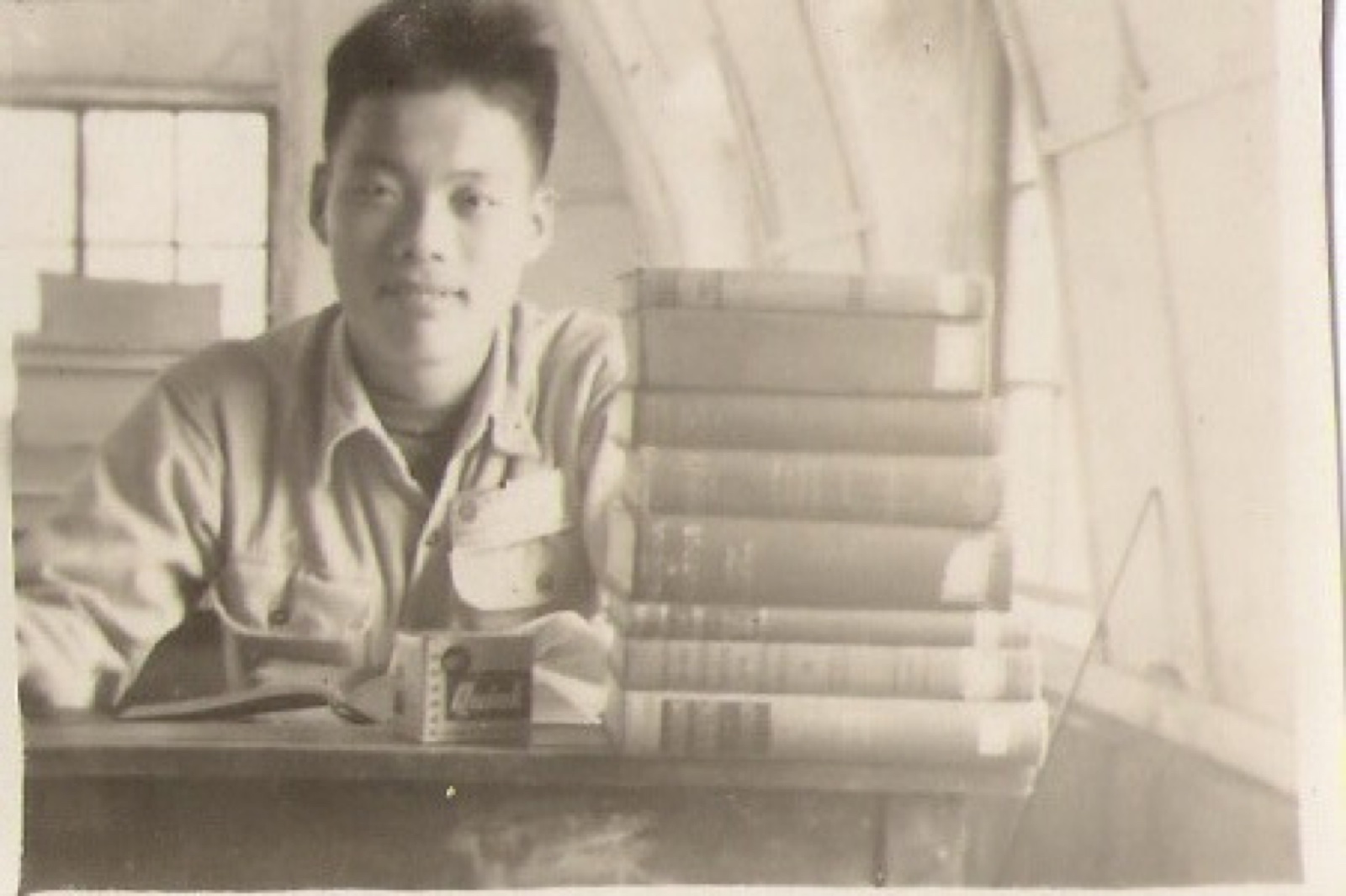 Shinn-Der Chang seated at a desk with books at National Taiwan University, 1956