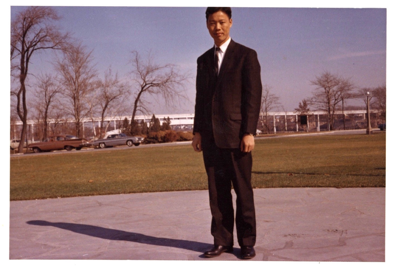 Shinn-Der Chang in a suit standing on a sidewalk, Ottawa, 1963