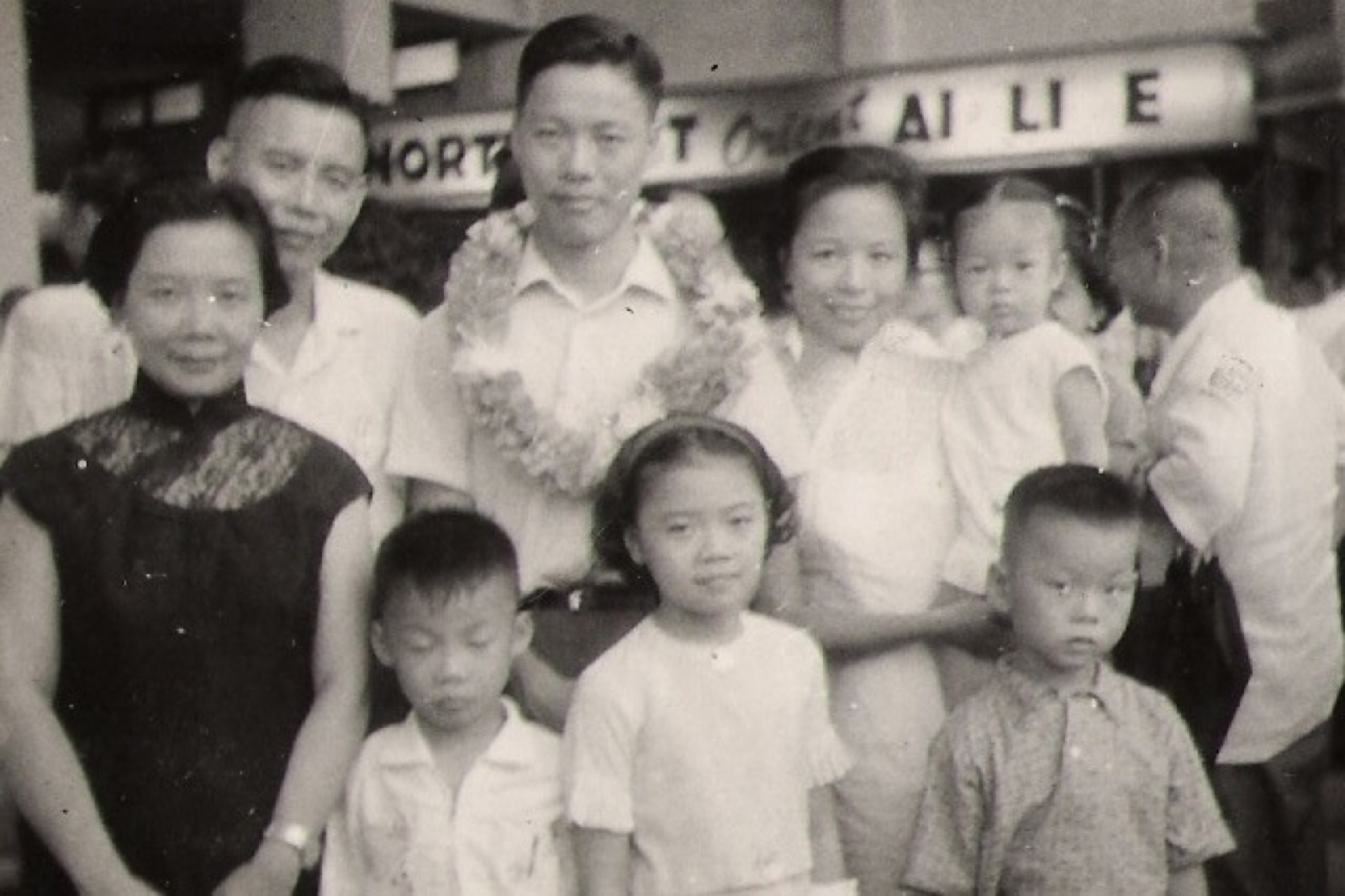 Family group photo with adults and children outside a building, Taiwan, 1963
