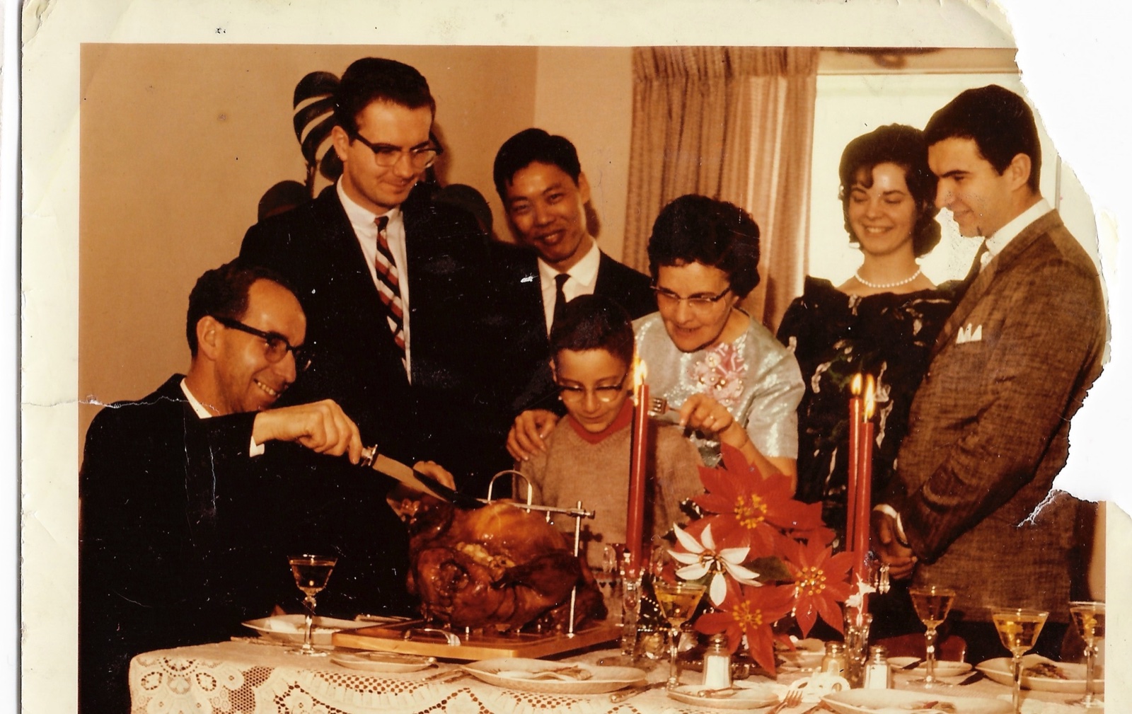 Group seated around a Christmas dinner table with a turkey, 1966