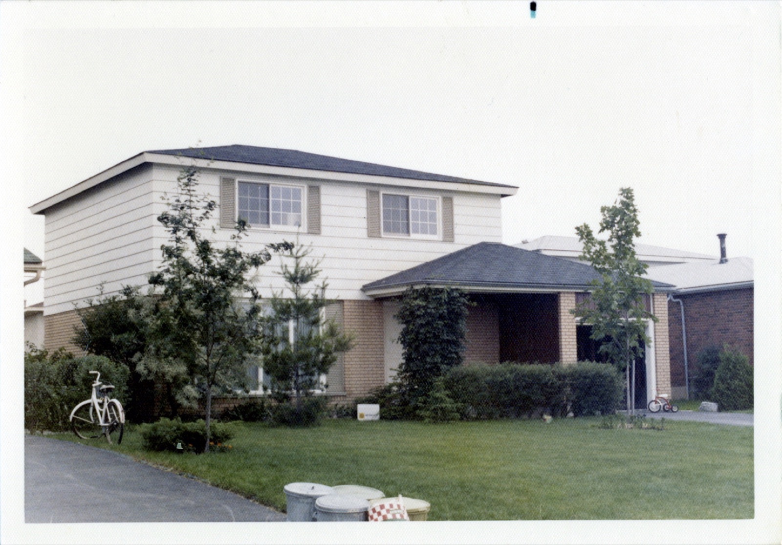 The exterior of the Tubman Crescent house with its yard and driveway, Ottawa, 1971