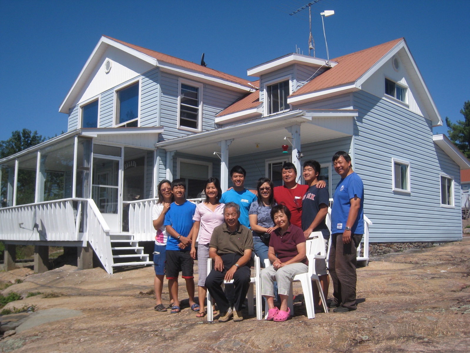 Family standing in front of the cottage on the Pickerel River, August 2011