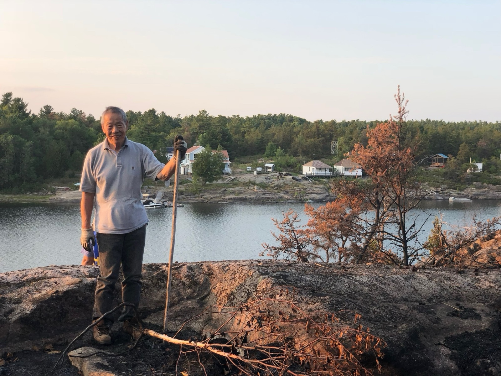 Shinn-Der Chang standing by the lake in front of the cottage, August 2018